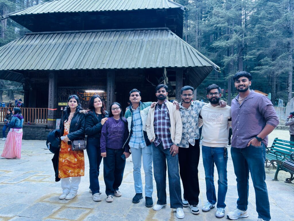 Group trip photos: a Yaarana Safar group standing together outside the Hadimba Devi Temple in Manali